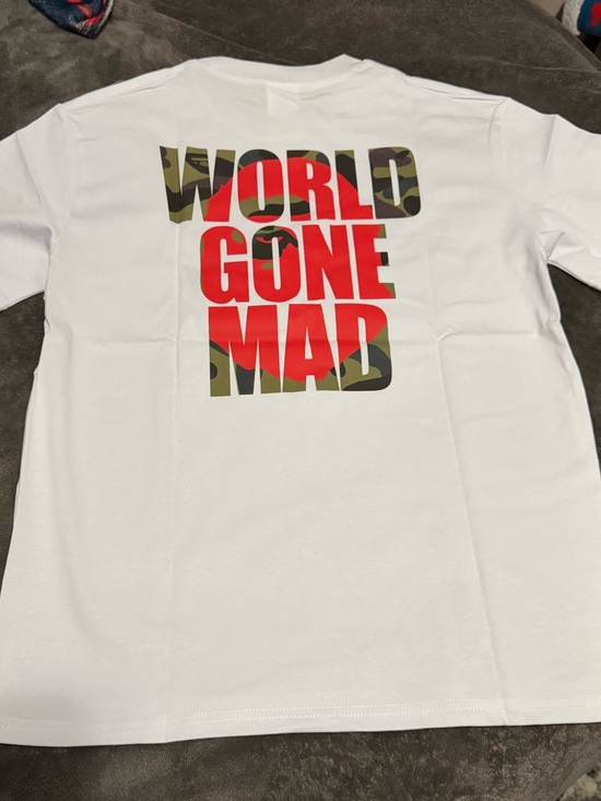 Stussy Tops - White Graphic Tee "WORLD GONE MAD" - Red & Camo Print
